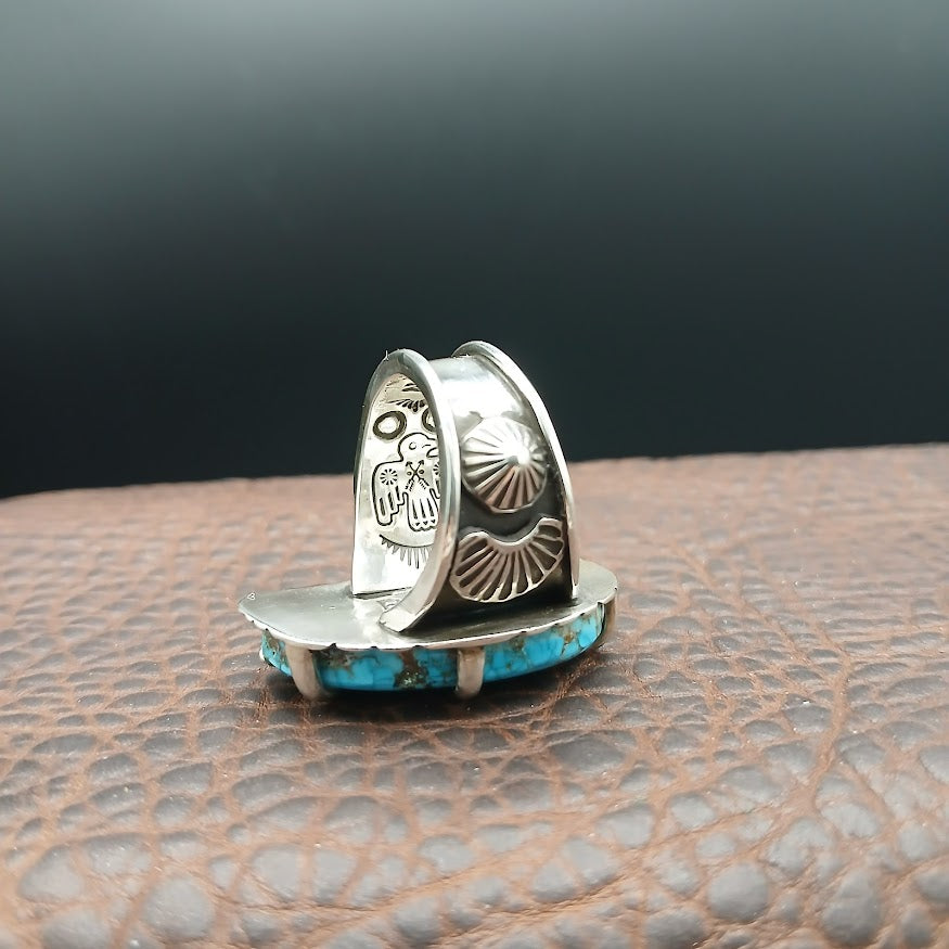 Silver and turquoise ring with embellishments and stamping on band with dark leather