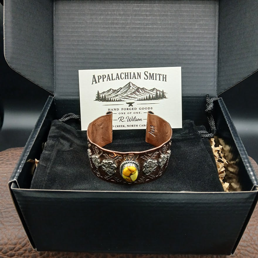 Copper bracelet with a yellow stone in a black box, featuring Appalachian Smith branding.