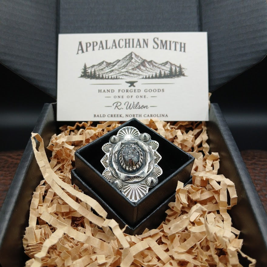 Silver ring in a box with decorative paper and an Appalachian Smith branded card.