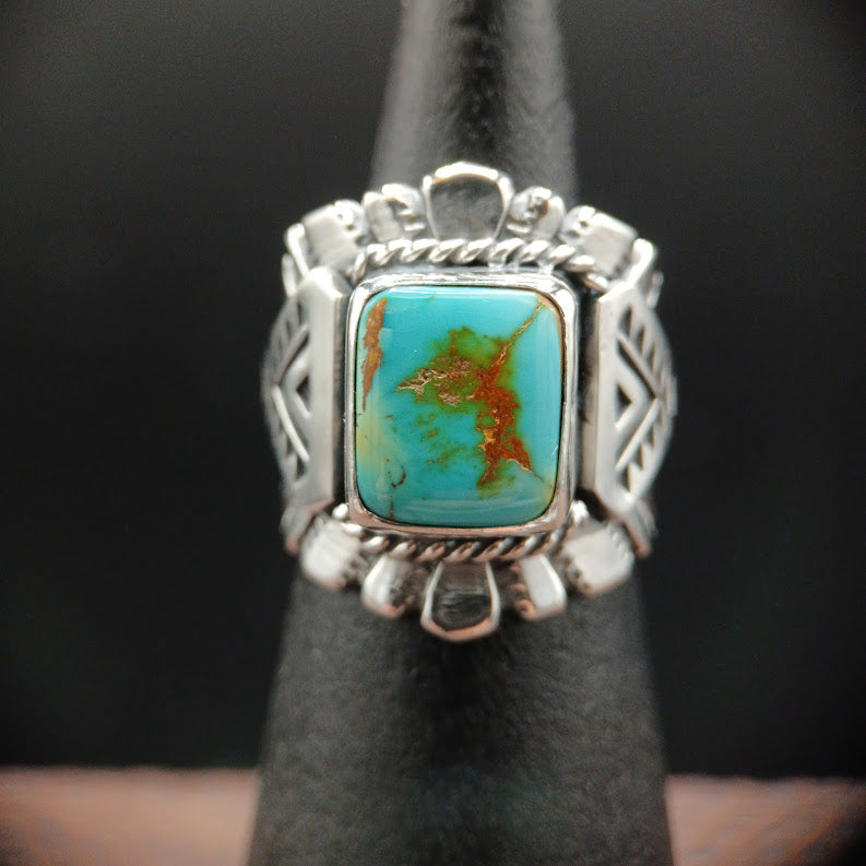 Silver ring with a turquoise stone on a dark background