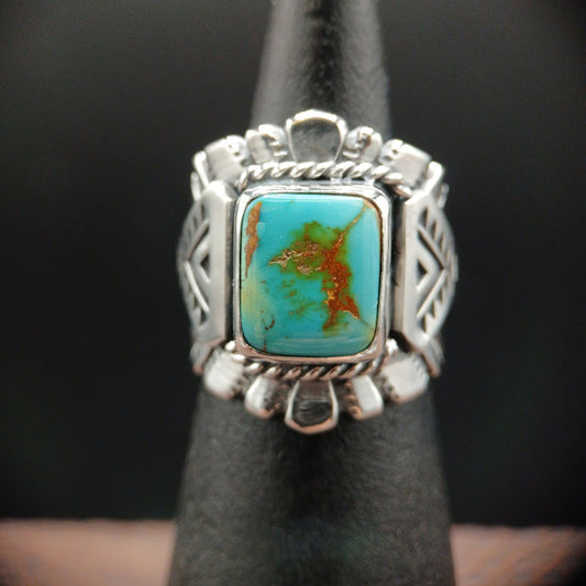 Silver ring with a turquoise stone on a dark background