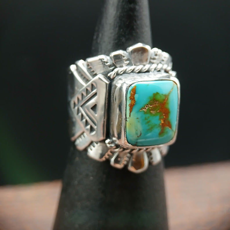 Silver ring with a turquoise stone on a dark background