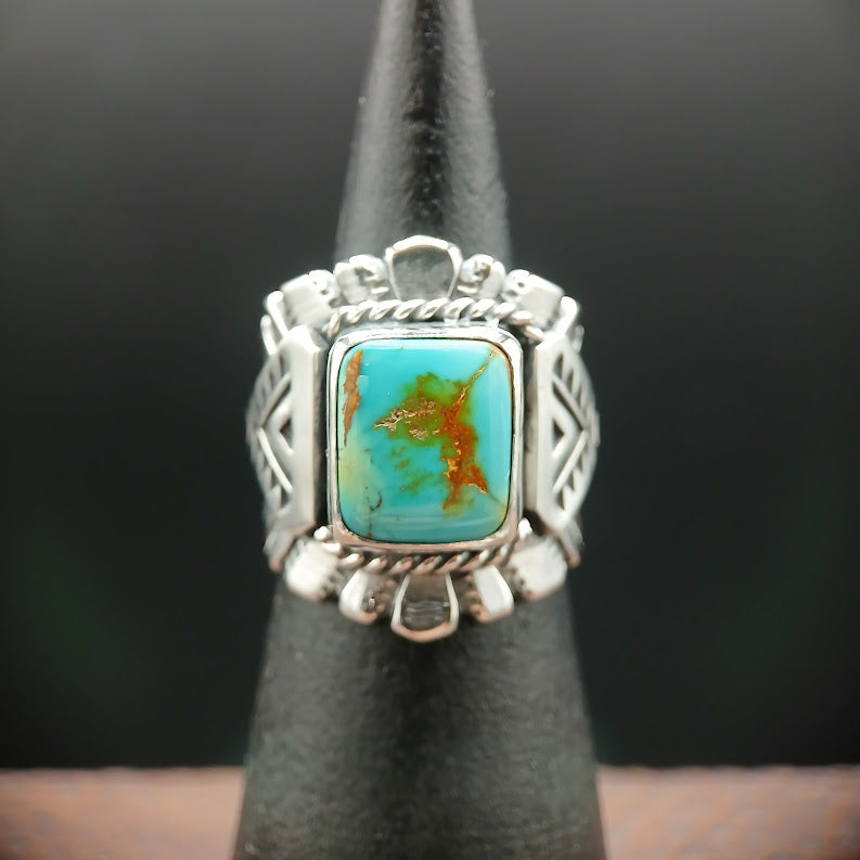 Silver ring with a turquoise stone on a black background