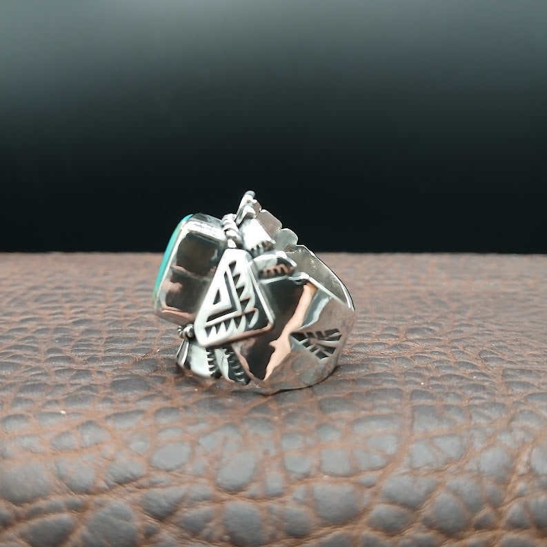Silver ring with geometric design on a textured surface