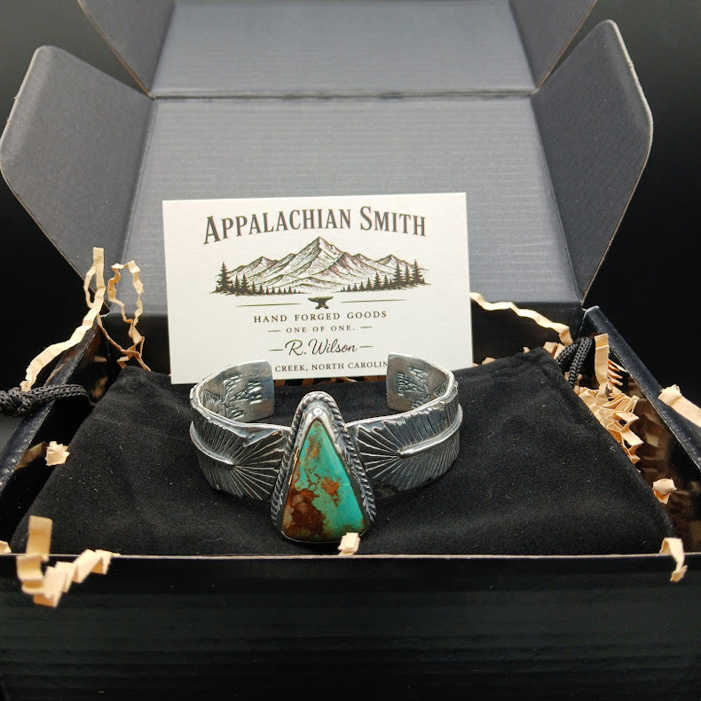 Silver bracelet with a turquoise stone in a box with Appalachian Smith branding