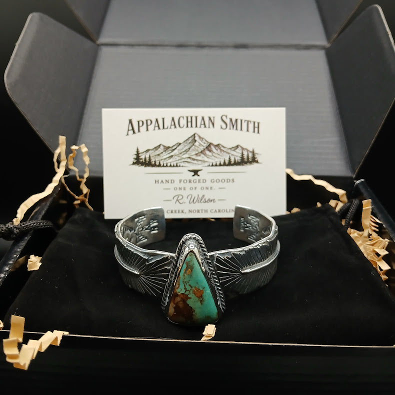 Silver bracelet with turquoise stone in a box with 'Appalachian Smith' branding