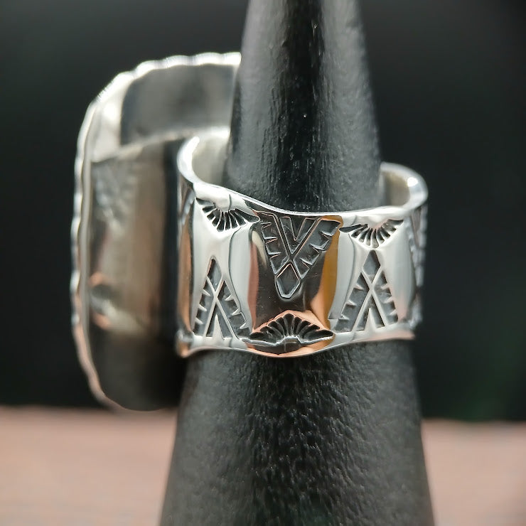 Wide sterling silver statement ring on ring mandrel, full band width visible with hand-stamped geometric pattern