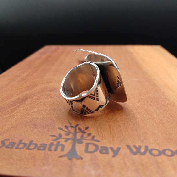 Side profile of The Hardscrabble turquoise ring showing band height and bezel depth, sterling silver, leather surface