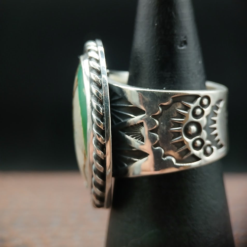 Royston ribbon turquoise sterling silver ring — Zia sun symbol stamp detail, black cone display