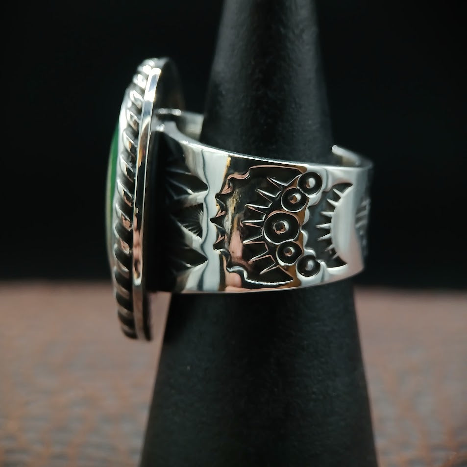 Royston ribbon turquoise ring — Zia sun and solar cross motifs on band, black cone display