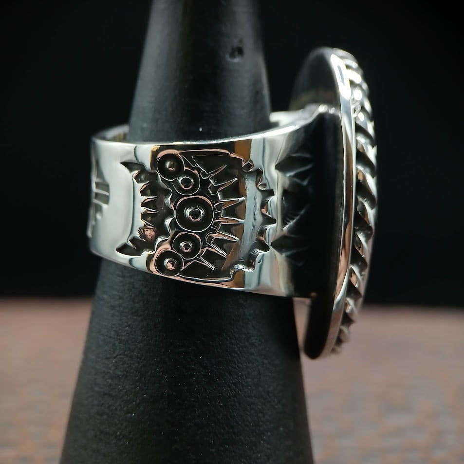 Royston ribbon turquoise ring — back band with Zia cross centered, black cone display