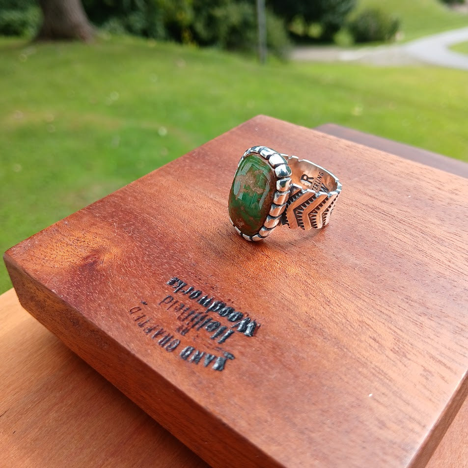 The Camelot — stone face-on, wood prop, outdoor, forest green stone