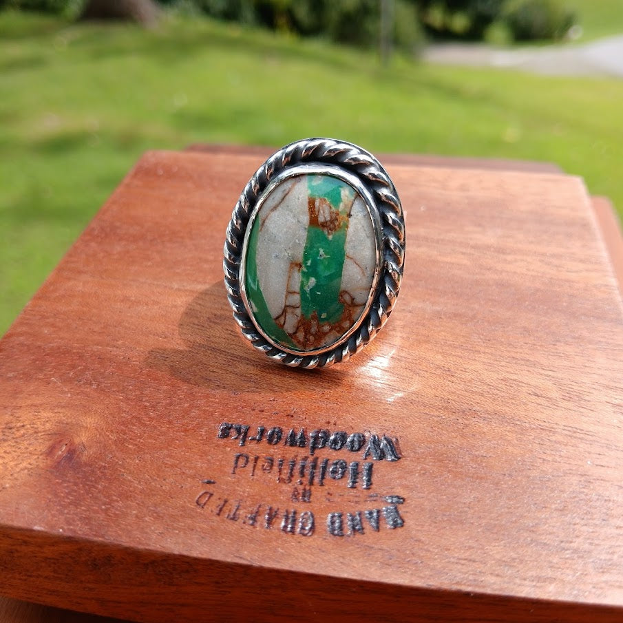 Royston ribbon turquoise ring — right profile, stone edge and stamp shoulder, black cone