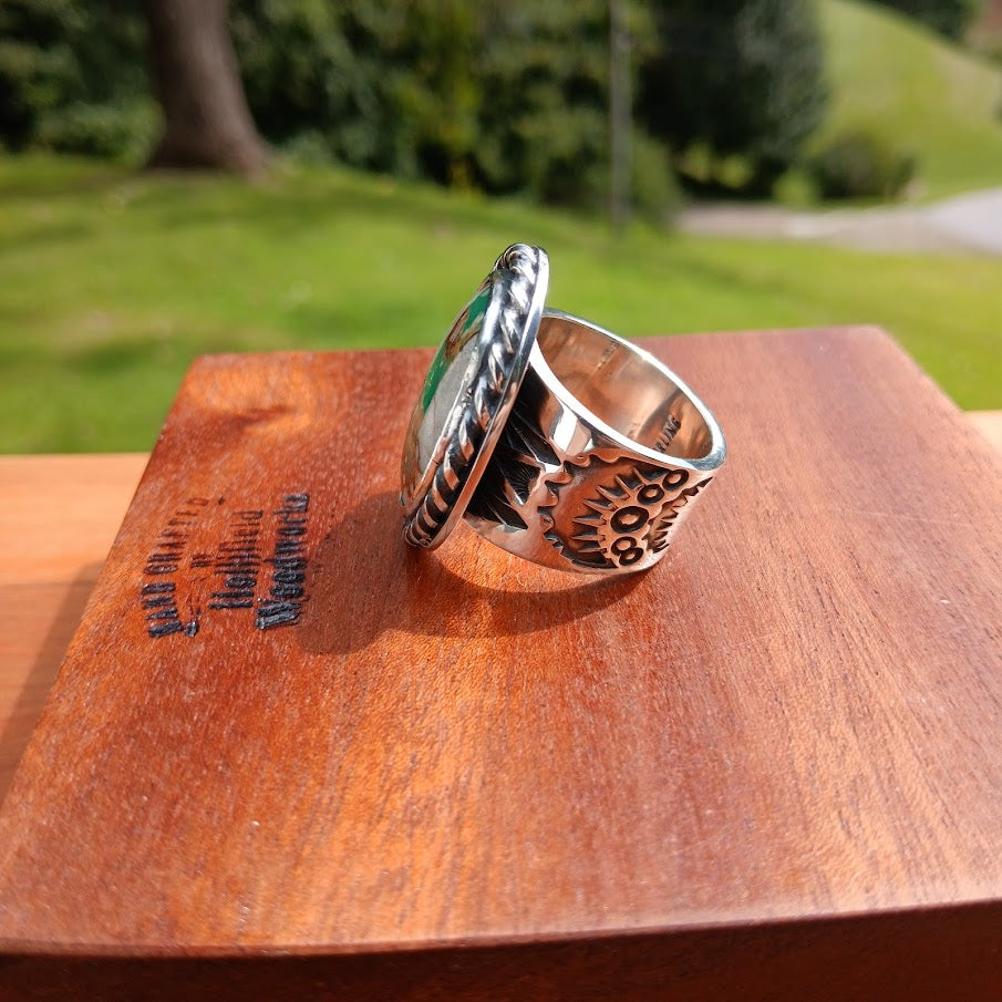 Royston ribbon turquoise ring — 3/4 stone and sun motif shoulder, wood prop