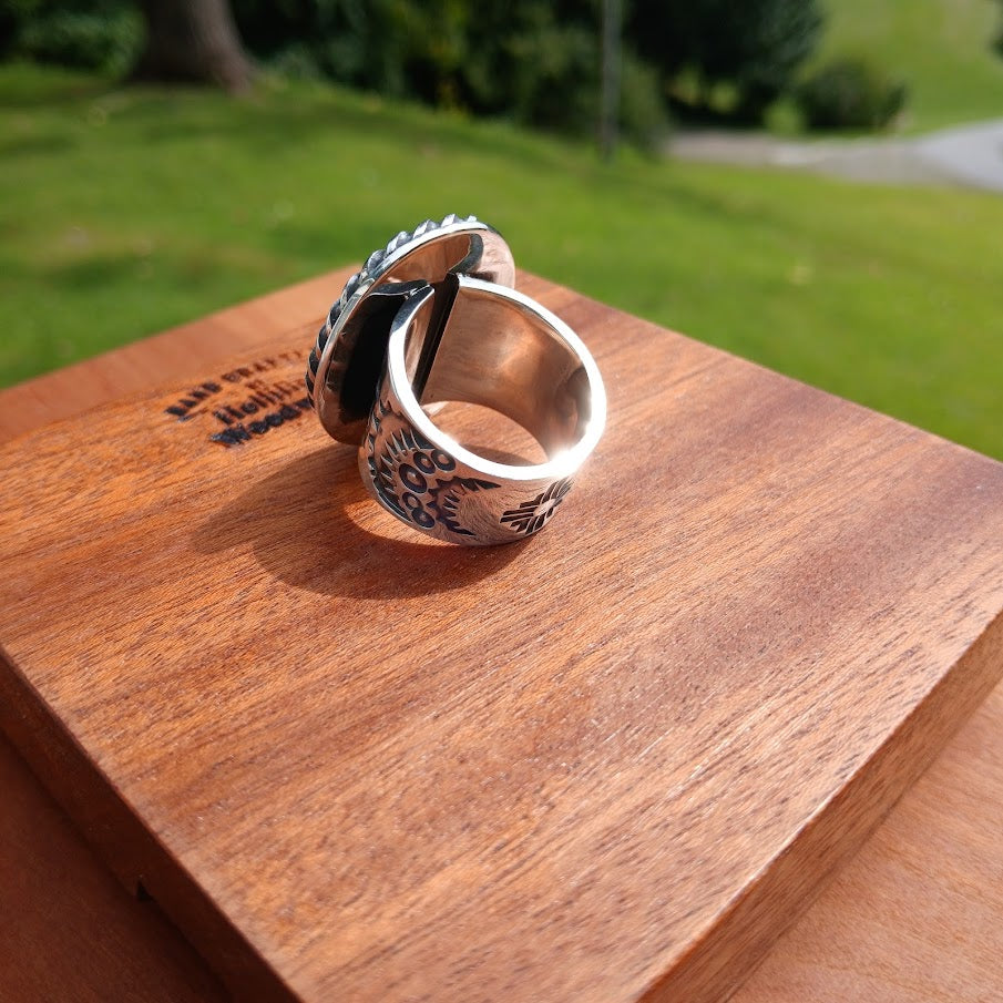 Royston ribbon turquoise ring — stone face, wood prop, stamp work on shoulder visible