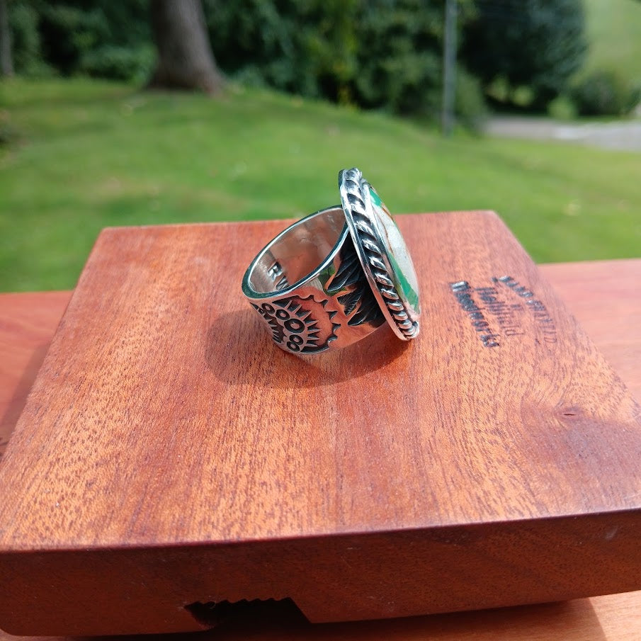Royston ribbon turquoise ring — right profile, stone and Zia sun motif, black cone
