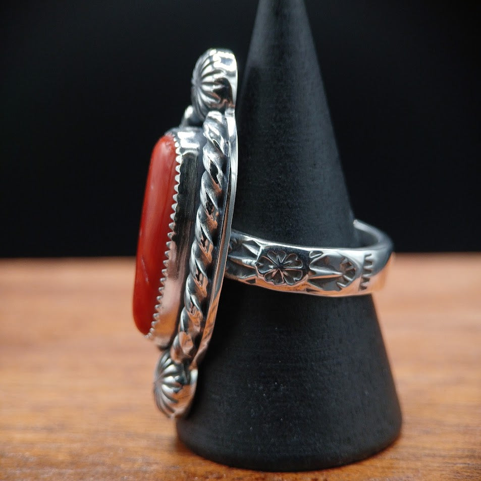 The Cardinal — top-down overhead, black cone, full composition coral + conchos + rope bezel