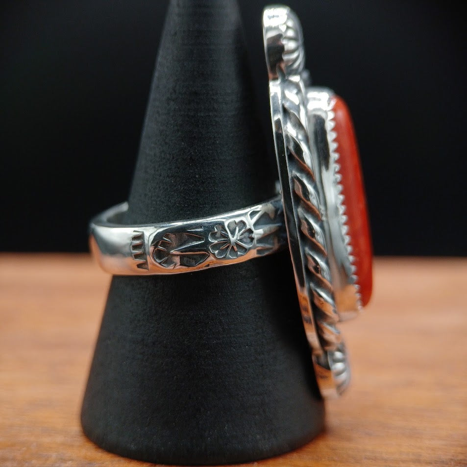 The Cardinal — left profile, black cone, stamp band + rope bezel from left